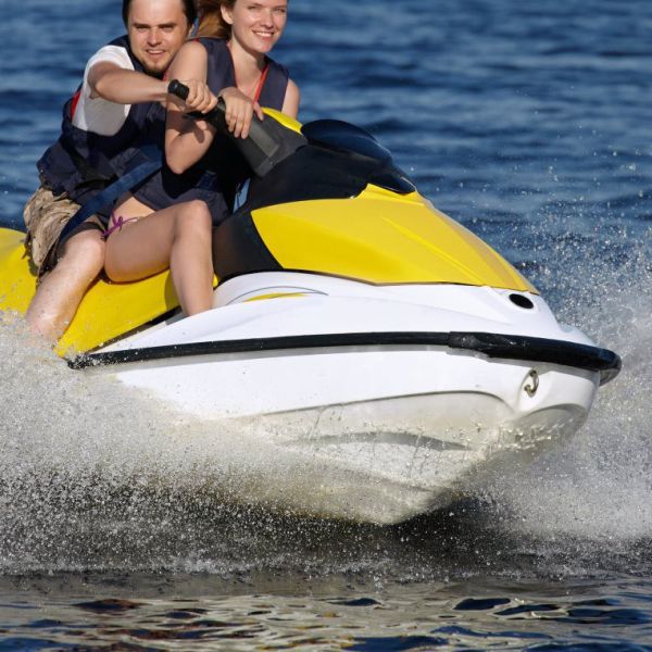 a person riding on the back of a boat in the water