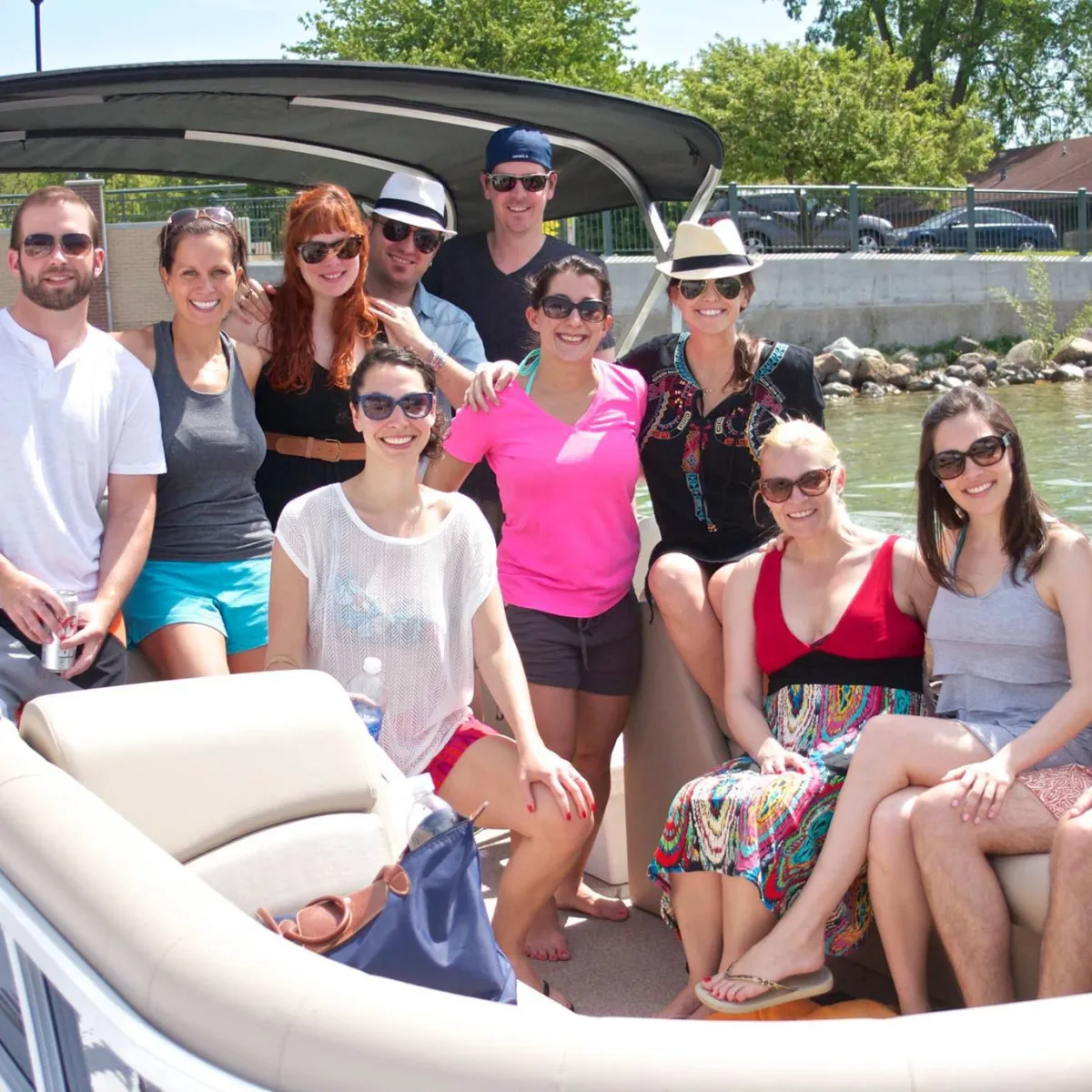 a group of people sitting in a car posing for the camera